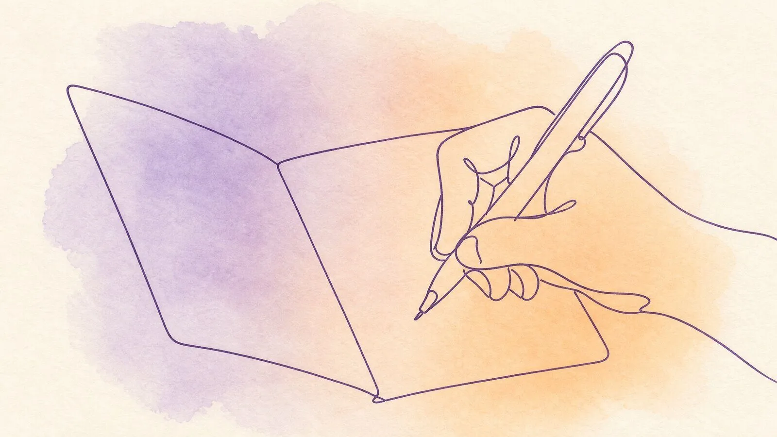 A hand writing inside a birthday card on a wooden table