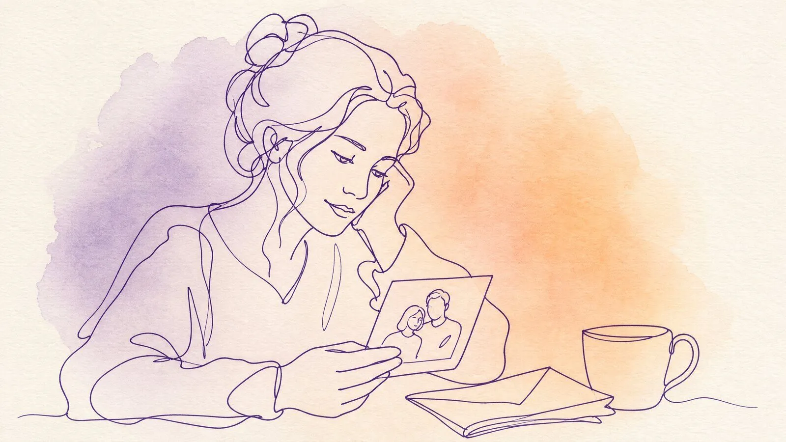 A woman at a kitchen table holding an old printed photograph, a mug and a folded letter beside it