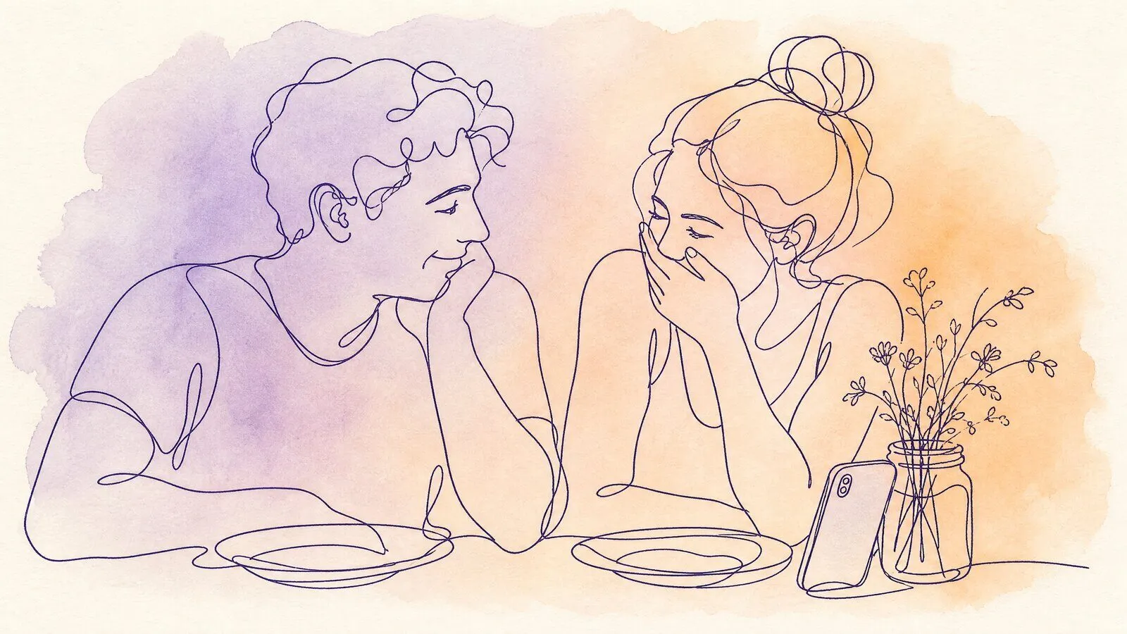 A couple at a small kitchen table with two plates and one phone propped against a jar of wild flowers, her hand over her mouth